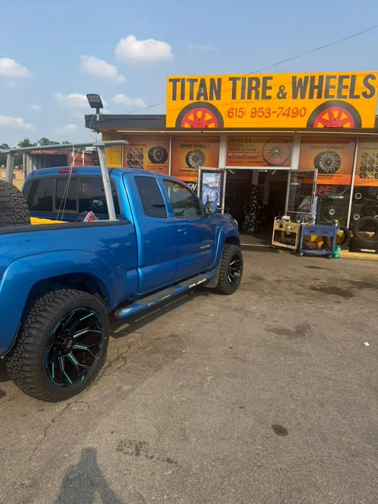 Titan Tire & Wheels storefront and blue truck outside the shop
