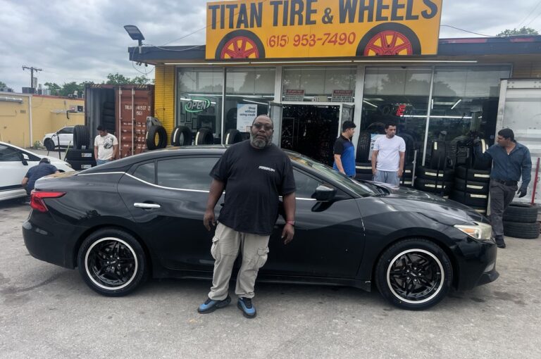 Front view of a black Nissan Maxima before new rims installation at Titan Tire & Wheels