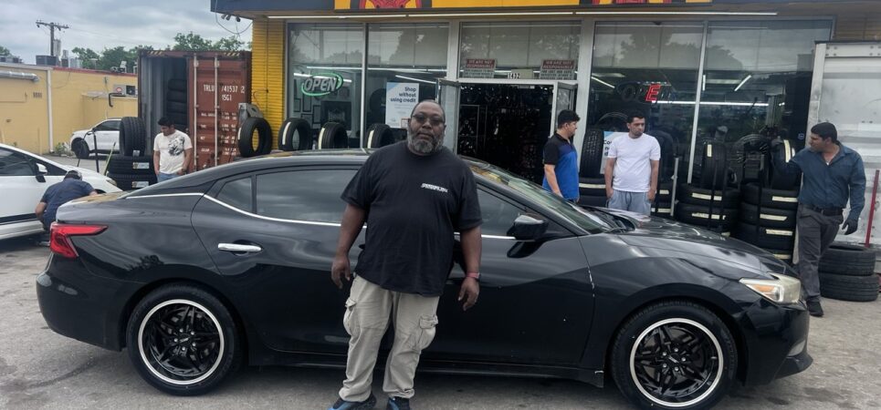 Front view of a black Nissan Maxima before new rims installation at Titan Tire & Wheels